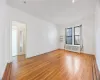 Unfurnished room with radiator and light hardwood / wood-style floors