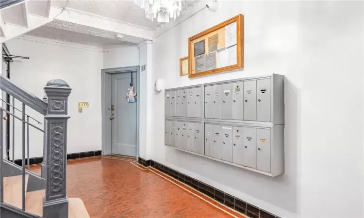 Foyer with a mail area and a textured ceiling