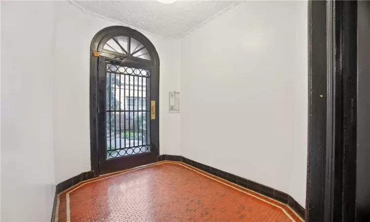 Foyer entrance with a textured ceiling