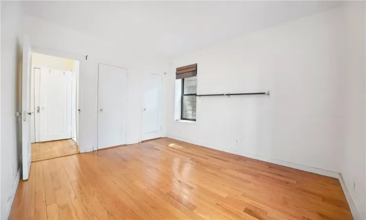 Unfurnished bedroom with light hardwood / wood-style flooring