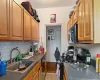 Kitchen featuring light wood-type flooring, stove, decorative backsplash, sink, and stainless steel dishwasher