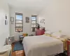 Bedroom featuring radiator, cooling unit, and hardwood / wood-style floors