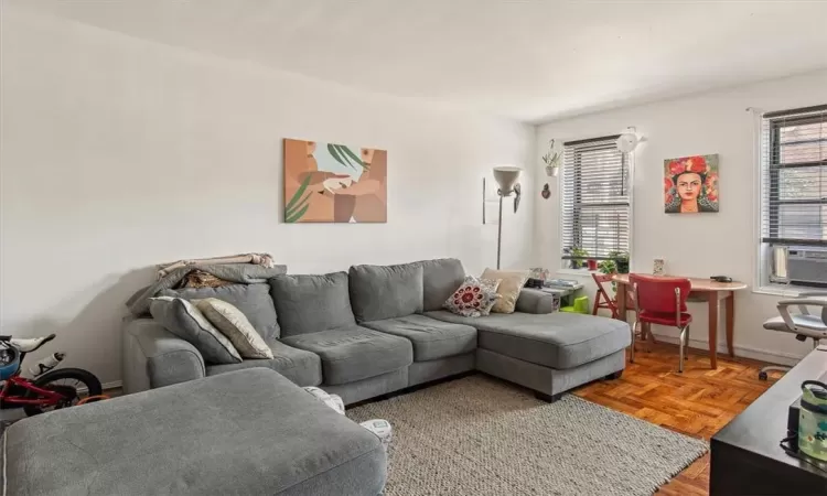 Living room with cooling unit and parquet flooring