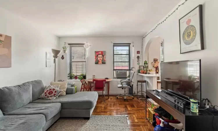 Living room with dark parquet floors and cooling unit