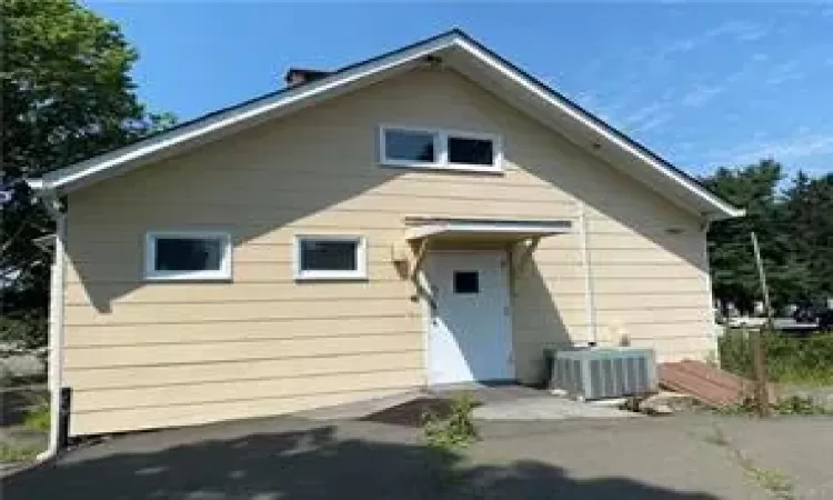 Rear view of house featuring central AC unit