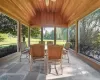 Sunroom featuring ceiling fan, vaulted ceiling, wooden ceiling, and a wealth of natural light