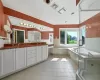 Bathroom with tile patterned floors, independent shower and bath, and dual vanity