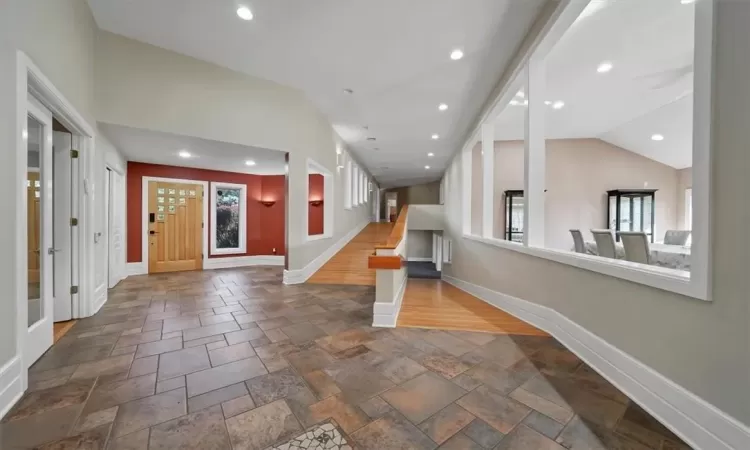 Entrance foyer featuring dark hardwood / wood-style flooring and vaulted ceiling