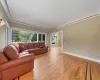 Living room featuring light hardwood / wood-style flooring and crown molding