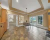 Dining room featuring light tile patterned floors and a raised ceiling