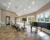 Tiled dining area featuring ceiling fan and lofted ceiling