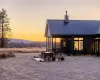 Back house at dusk with a sunroom