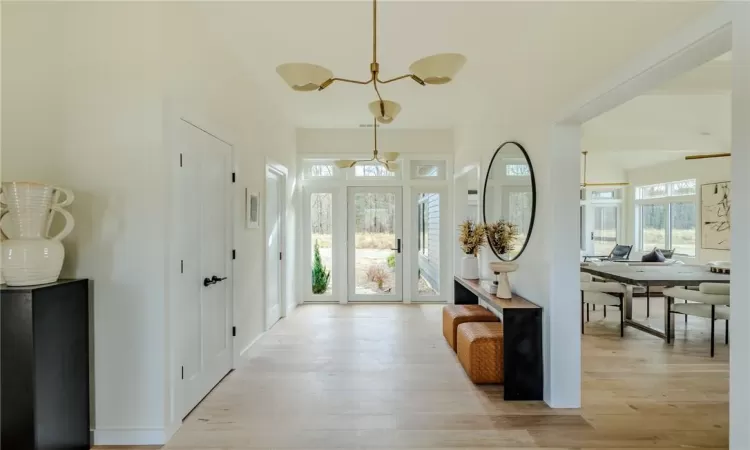 Ranch-style house featuring a garage, covered porch, and a carport