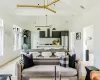 Living room with light wood-type flooring, beamed ceiling, and high vaulted ceiling