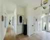 Entryway featuring light wood-type flooring and a notable chandelier