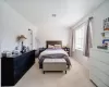 Bedroom featuring light carpet