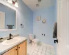 Bathroom featuring toilet, vanity, and tile patterned floors