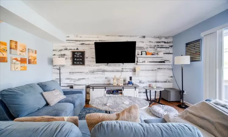 Living room featuring wood walls and hardwood / wood-style flooring