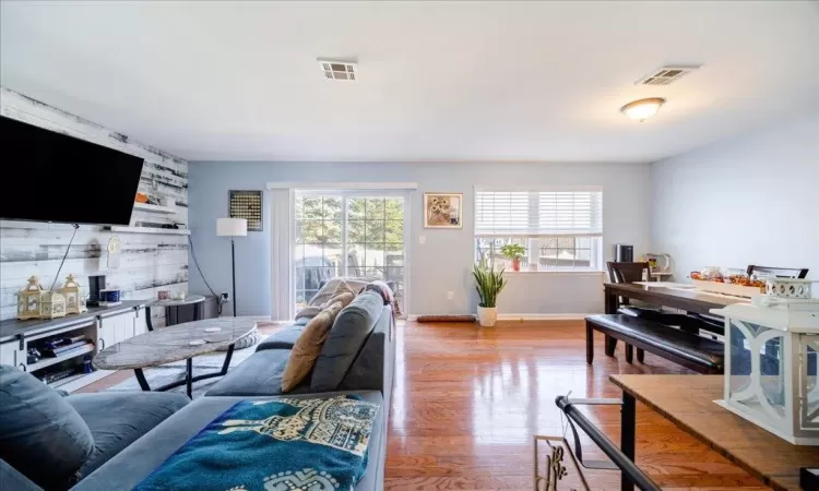 Living room featuring a healthy amount of sunlight and light wood-type flooring