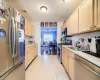 Kitchen with light brown cabinetry, appliances with stainless steel finishes, and sink