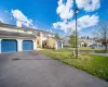 View of front facade with a garage and a yard