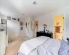 Carpeted bedroom featuring ensuite bathroom and a closet