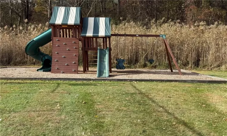 View of jungle gym with a yard