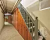 Staircase with wood walls and a baseboard heating unit