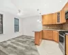 Kitchen featuring pendant lighting, stainless steel gas range, decorative backsplash, ceiling fan, and kitchen peninsula