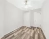 Unfurnished bedroom with ceiling fan and wood-type flooring