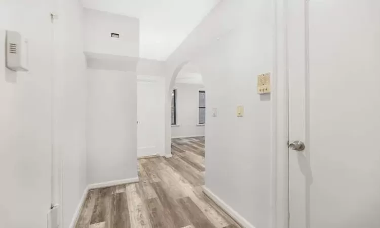 Hall with light hardwood / wood-style floors