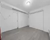 Basement with light hardwood / wood-style floors and baseboard heating