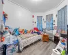 Bedroom featuring light wood-type flooring and crown molding