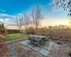 Patio terrace at dusk with a lawn