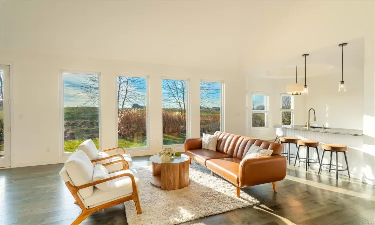 Sunroom featuring lofted ceiling and sink