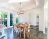 Dining room featuring a raised ceiling and dark wood-type flooring