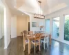 Dining room with dark wood-type flooring and an inviting chandelier