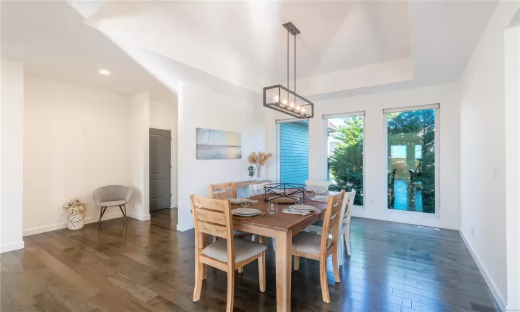 Dining room with dark hardwood / wood-style flooring