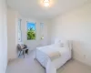 Bedroom featuring light carpet and crown molding