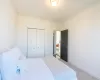 Bedroom featuring light colored carpet, a closet, and ornamental molding