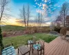 Deck at dusk featuring a yard and a patio