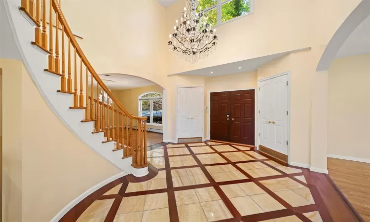 Grand Entrance foyer with a high ceiling and chandelier