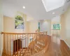 Corridor with hardwood / wood-style floors and lofted ceiling