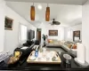 Living room featuring ceiling fan and lofted ceiling