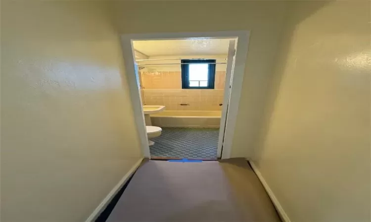 Hallway featuring a textured ceiling