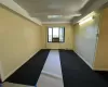 Spare room featuring beamed ceiling and carpet flooring