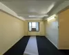 Unfurnished room with beamed ceiling and carpet flooring