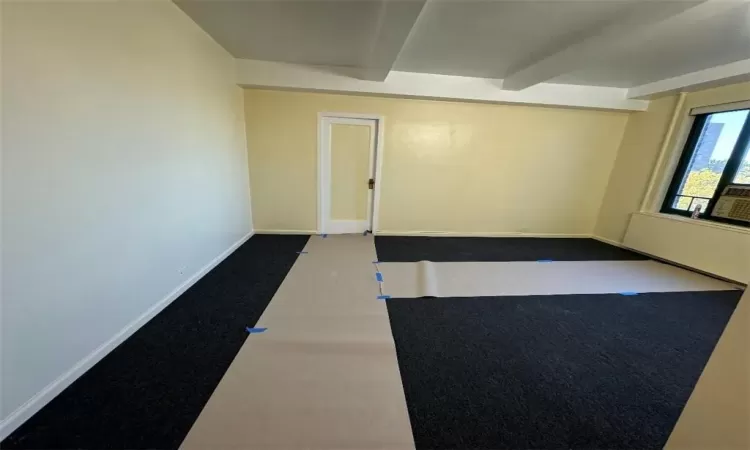 Unfurnished room featuring beamed ceiling and basketball court