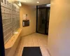 Hallway with light tile patterned floors and mail boxes