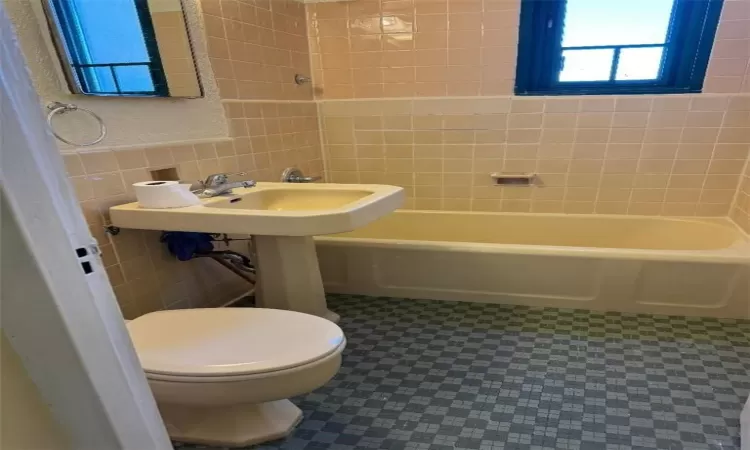 Bathroom with tile walls and toilet